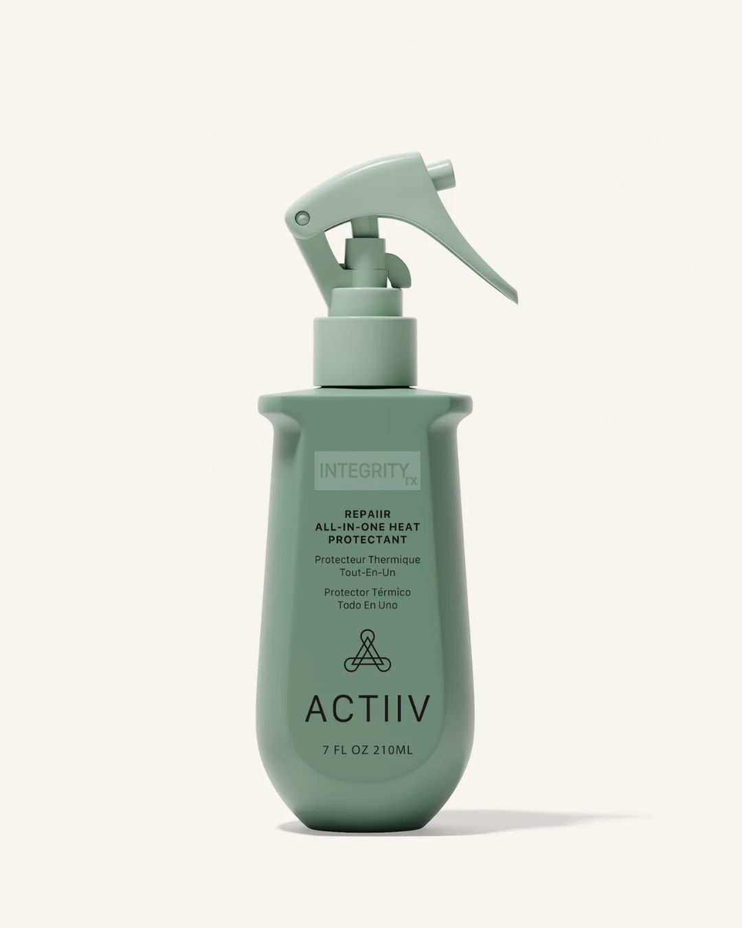 A green spray bottle labeled “Actiiv” with text indicating it is a 10-in-1 all-over heat protectant for hair, containing 230 ml.