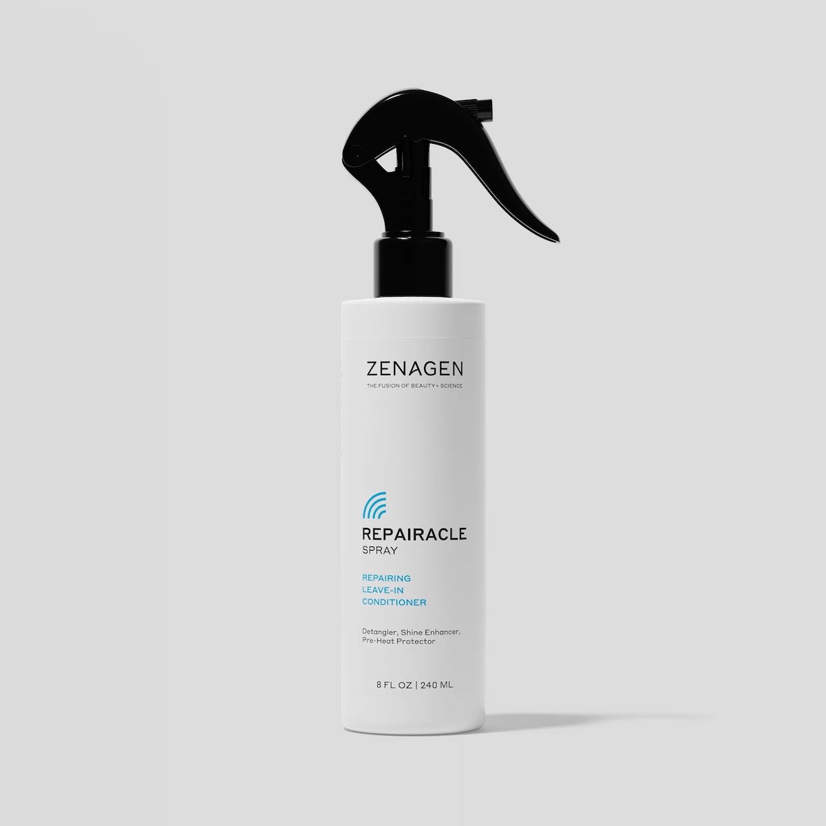 A white spray bottle labeled “Zenagen Repairacle Spray” stands upright on a light gray background.