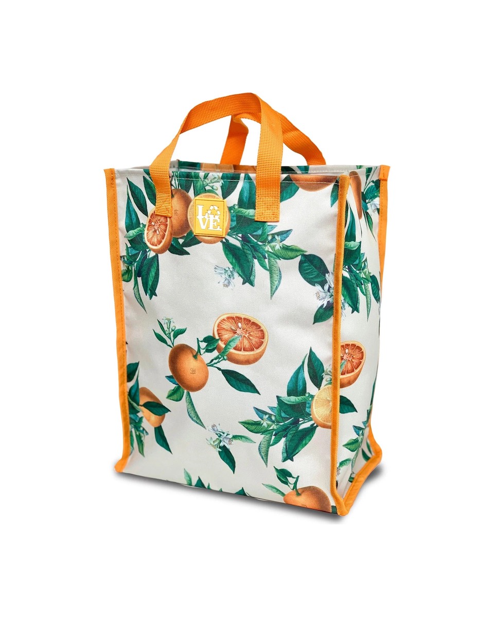 White reusable shopping bag with an orange fruit and green leaf pattern and orange trim.