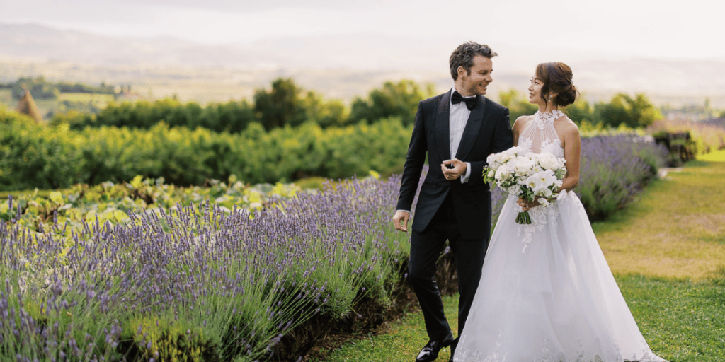 couple hold hands by lavender