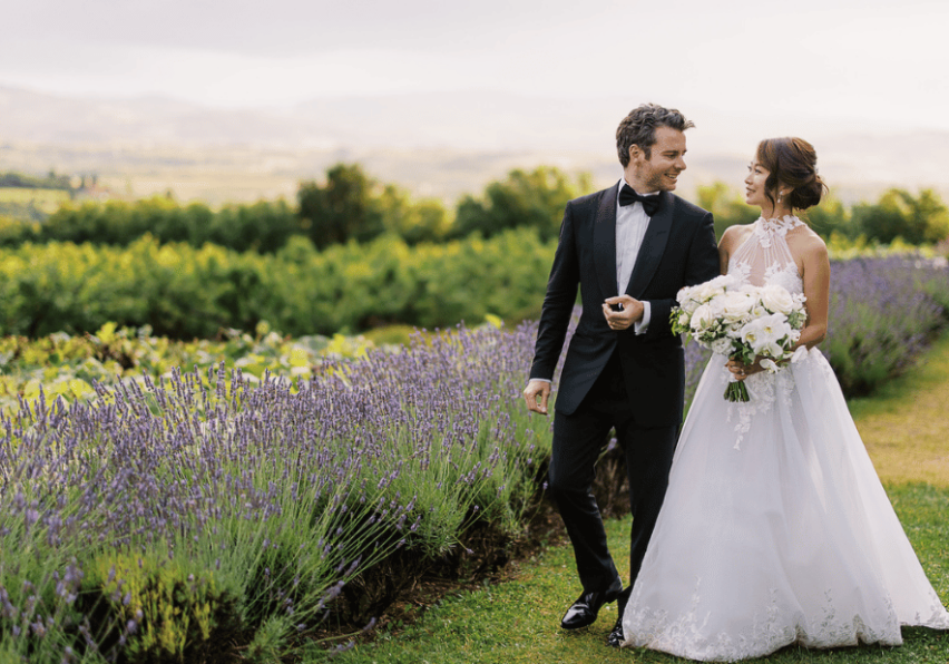 couple hold hands by lavender