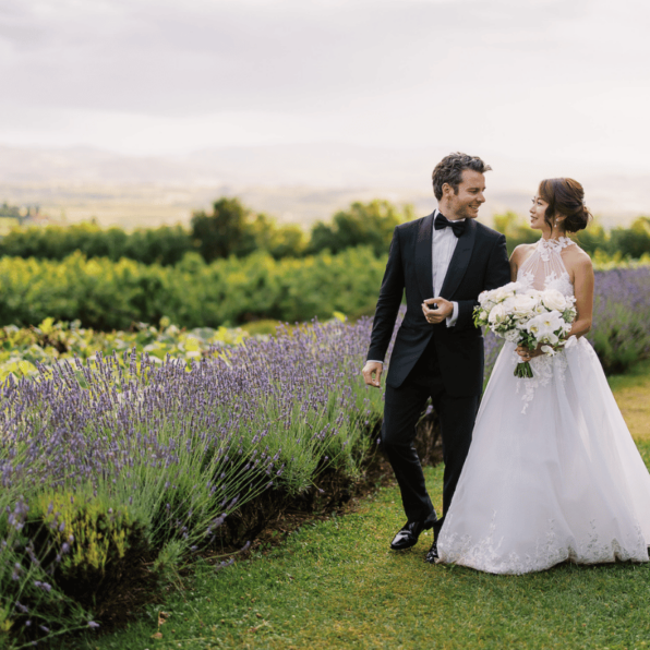 couple hold hands by lavender