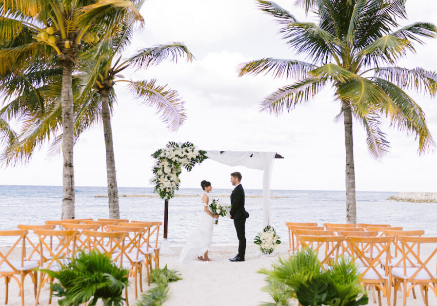 tropical beach wedding ceremony with bride and groom
