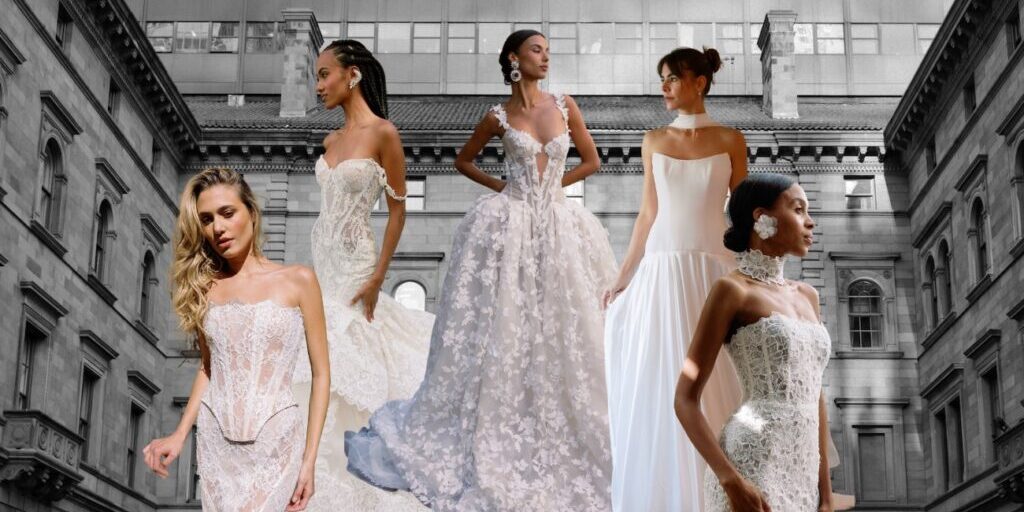 Five models in various bridal gowns stand in front of a historic building with large windows.