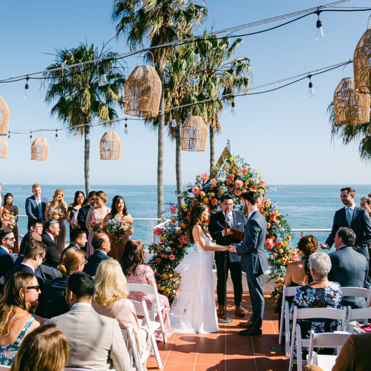 Ocean front terrace wedding at Casa Loma Beach Hotel in Laguna Beach, California. Photos by Kate Noelle.