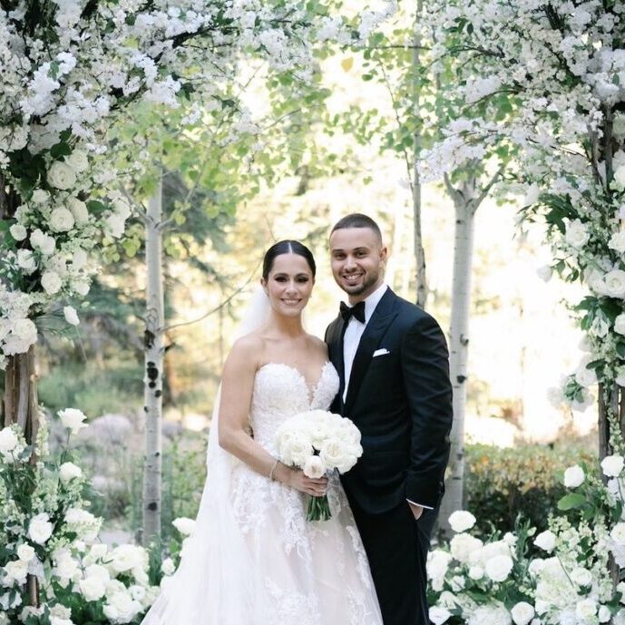 Tiffany and Daniel at altar with two white floral trees